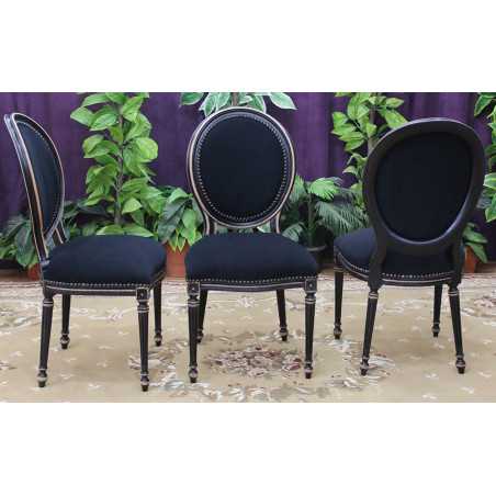 LOT 12 CHAISES MEDAILLON STYLE LOUIS XVI - Vernis noir marbré - "PROMO STOCK -20%"Lot 12 Chaises Médaillon en stock au prix de 199€ l’unité au lieu de 249€.La finition du bois est réalisée avec un vernis noir appliqué sur le hêtre massif. Après vernissage, certaines parties et certains reliefs sont poncés manuellement à la main afin de faire réapparaître volontairement le bois brut sous la finition noire.Ce travail artisanal crée un effet patiné et légèrement vieilli, avec un contraste naturel entre le noir verni et le bois brut apparent. Cette finition est associée à un revêtement en velours noir.Caractéristiques :Style : Louis XVI / MédaillonStructure : hêtre 100% massifFabrication : renforcée pour une utilisation quotidienne ou intensiveUtilisation : particuliers, restaurants, hôtels, cafés et professionnelsRevêtement : velours noir moderneFinition : bois verni noir avec ponçage manuel faisant apparaître le bois brut par endroitsEffet : patiné et légèrement vieilliHauteur d’assise : 48/50 cmHauteur totale : 100/101 cmLargeur : 48/50cm